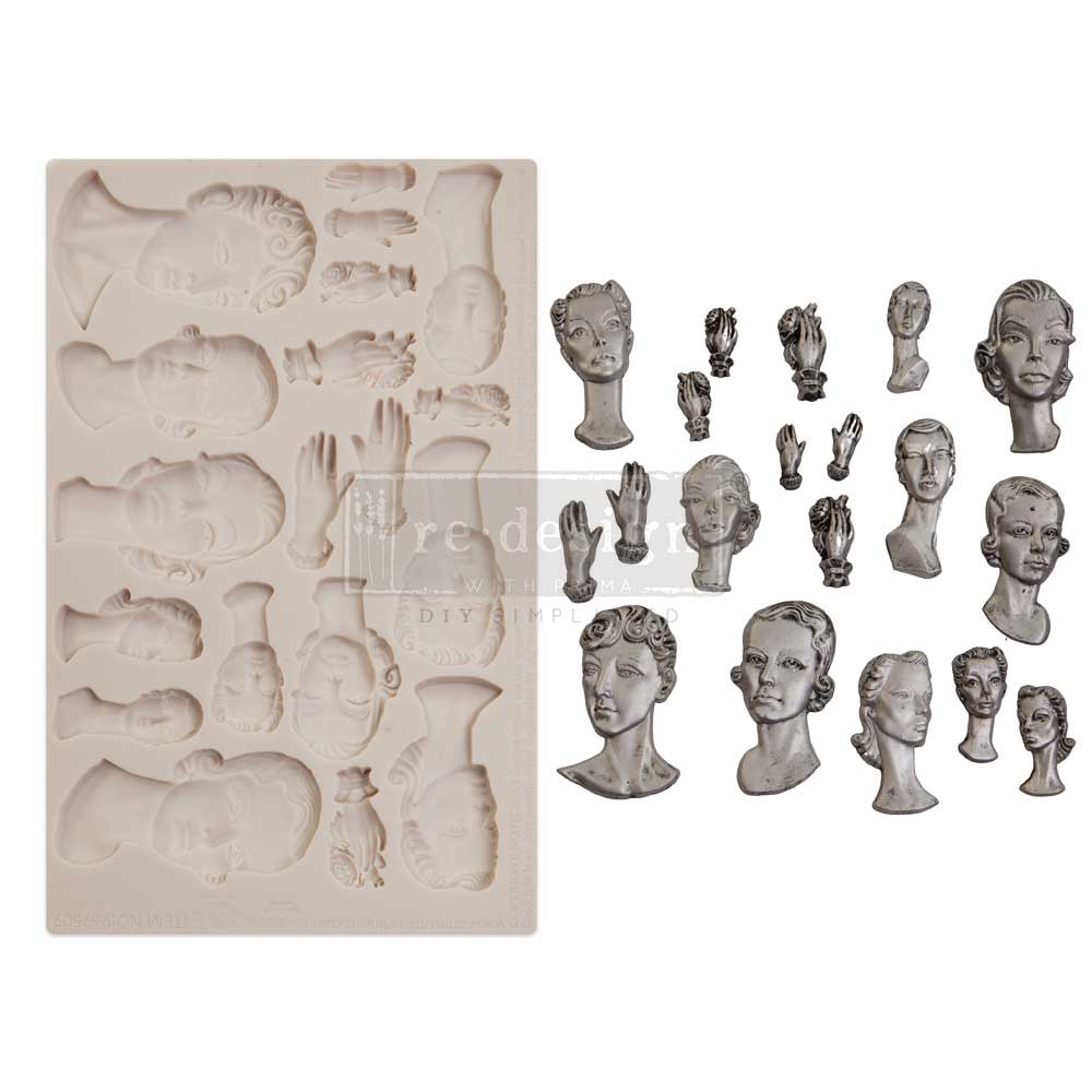 A product image displays a cream-colored silicone décor mould beside a collection of finished castings in an antique silver-gray metallic finish. The mould contains cavities for multiple sculptural portrait busts, expressive hands, cameo-style medallions, and ornamental finials. On the right side, the completed cast pieces are arranged neatly against a light background. The busts depict elegant vintage-inspired male and female faces with stylized curled hairstyles, elongated necks, and refined art deco feat