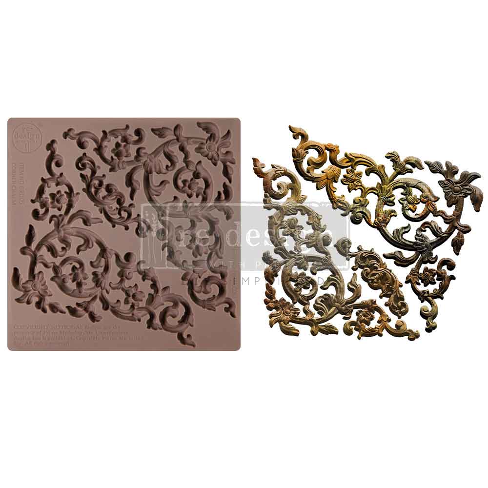 A side-by-side product display features a silicone décor mould on the left and finished decorative castings on the right. The mould is a square brown silicone sheet filled with intricate swirling floral and scroll motifs inspired by baroque and rococo ornamentation. The finished pieces on the right are painted in antique metallic tones of gold, bronze, and silver with dark shading to emphasize depth and detail. The embellishments include curling vines, stylized flowers, and ornate scrollwork that can be lay