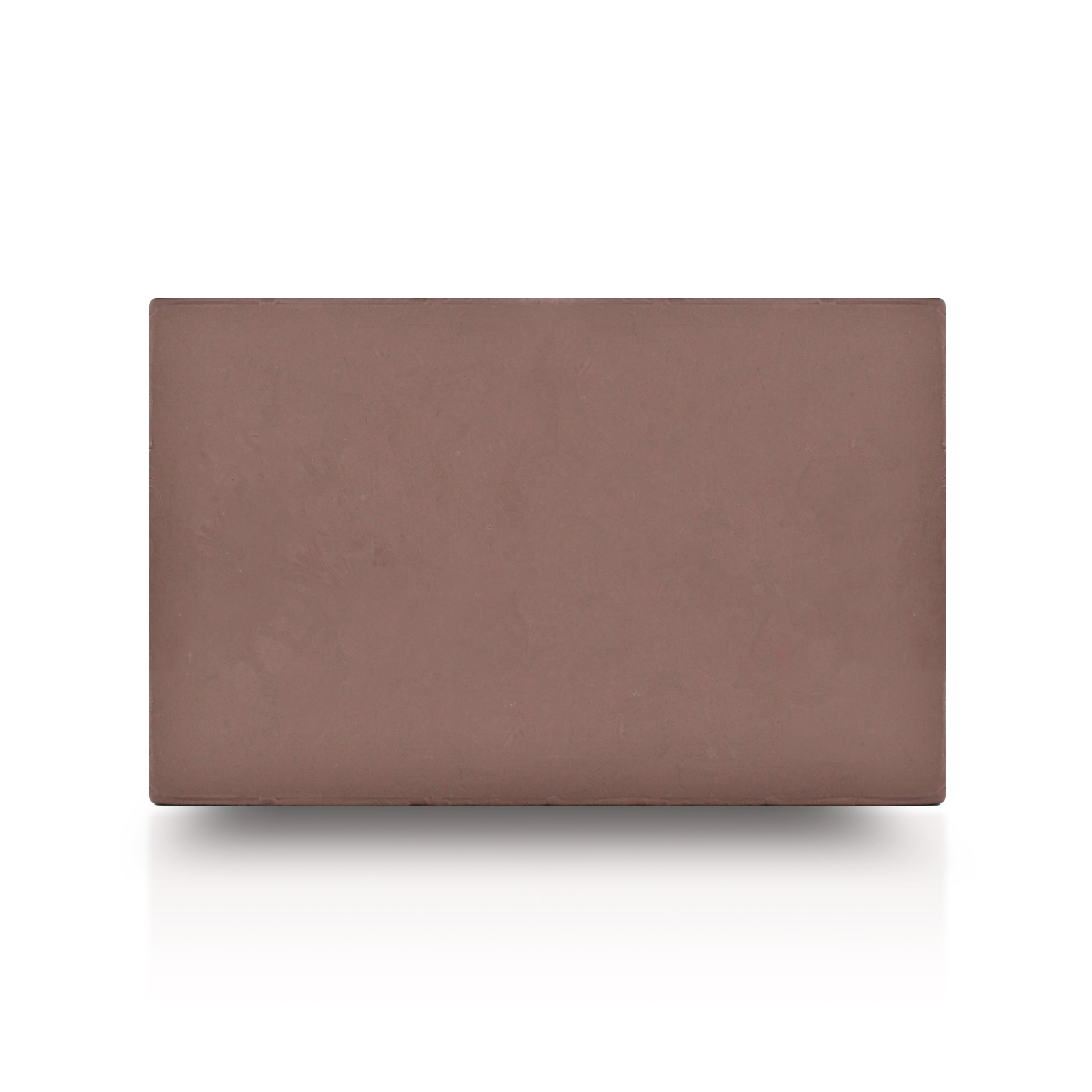 Rectangular block of brown oil-based sculpting clay with a smooth matte surface displayed on a light gray background.