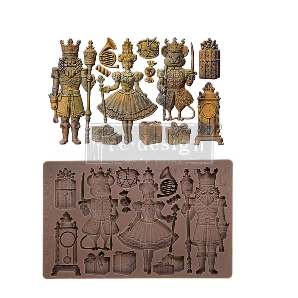 A product image showcasing a “Nutcracker Party” silicone décor mold alongside finished metallic cast embellishments. The top portion displays detailed antique gold-painted holiday figures and accessories, including a bearded nutcracker king holding a staff, a ballerina in a decorative dress, and a crowned mouse king holding a sword. Additional festive elements include wrapped gifts, a grandfather clock, a drum, candy, and a French horn. Below the finished pieces is the brown silicone mold used to create the