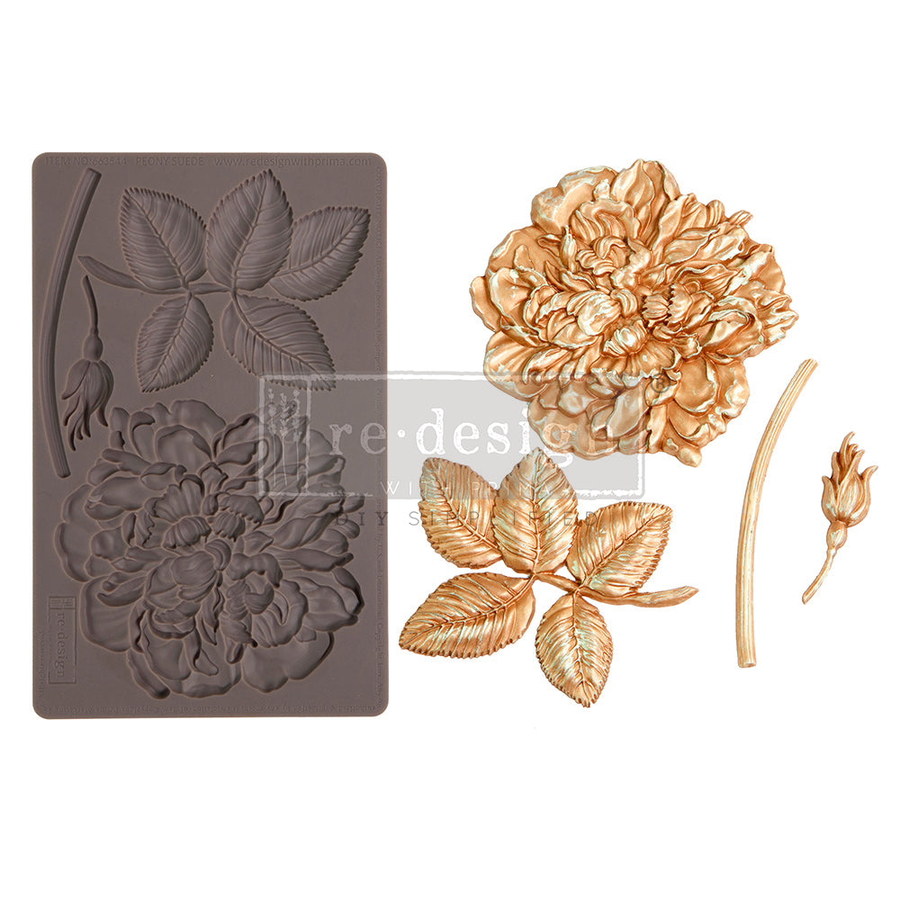 A product-style image showcases a decorative silicone mould alongside its finished floral cast pieces. On the left is a flexible rectangular silicone mould in a warm taupe-brown color featuring detailed recessed impressions of a large peony flower, layered leaves, a curved stem, and a flower bud. The mould captures intricate petal folds and leaf veining for dimensional realism.