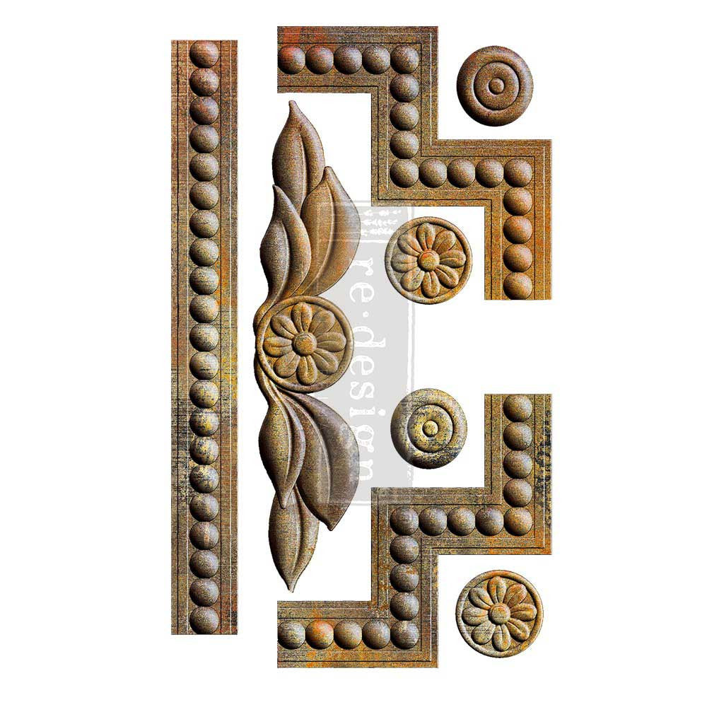 A collection of ornate decorative embellishment designs displayed against a white background in an antique bronze finish. The set includes long beaded trim strips, geometric corner pieces with rounded bead details, circular floral medallions, and a central leaf-and-flower motif featuring layered leaves surrounding a rosette flower. The pieces have a vintage architectural style inspired by classic furniture molding and decorative trim, with softly aged metallic coloring that highlights the dimensional detail