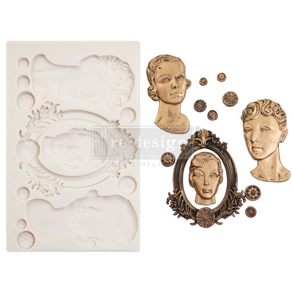 A side-by-side product display presents a cream-colored silicone décor mold on the left and finished cast embellishments on the right against a clean white background. The mold features three stylized classical female portrait busts, an ornate oval frame with floral flourishes, and several small circular medallion accents. The completed castings are finished in warm antique gold and bronze tones with dark shading that emphasizes their sculpted details. Two Art Deco-inspired female busts with sleek curled ha