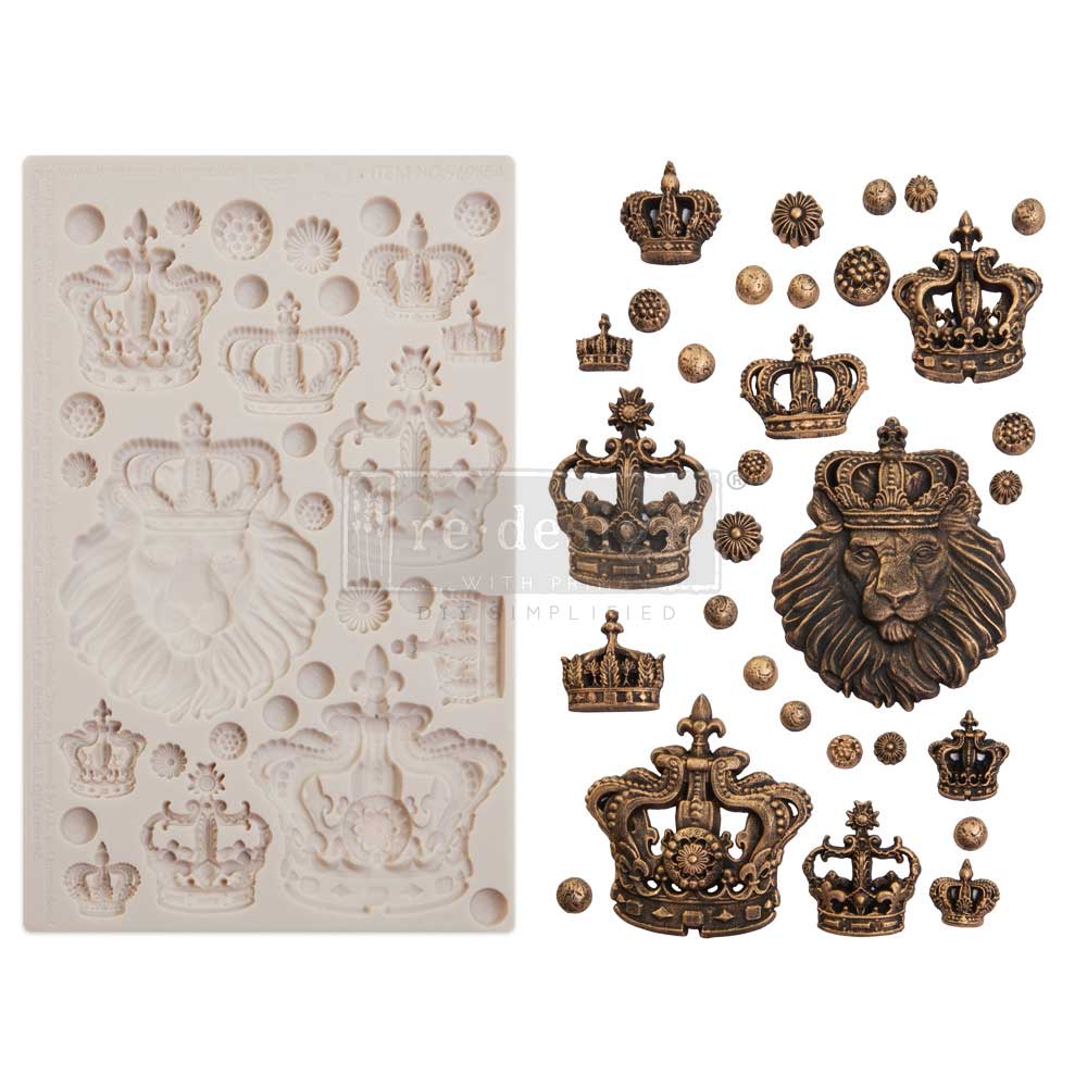 A side-by-side product image featuring a white silicone décor mold and its finished royal-themed cast embellishments. The mold on the left contains intricate crown designs, decorative medallions, and a large crowned lion head motif arranged across a rectangular tray. On the right, the completed embellishments are displayed in an antique bronze finish, highlighting ornate textures and regal details such as fleur-de-lis accents, jewel-like trim, and dimensional lion mane features. Small circular decorative ac