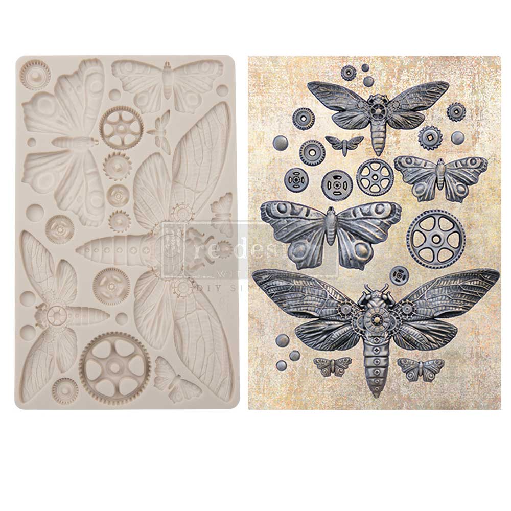 A side-by-side product display features a pale silicone mould on the left and finished embellishments on the right from the “Mecha Moth” collection. The mould contains detailed cavities shaped like moths, insect wings, gears, cogs, and small circular mechanical parts. The completed cast pieces on the right are painted in dark metallic silver and charcoal tones with steampunk-inspired detailing. Several moths of different sizes are arranged among gear-like embellishments, creating a fusion of natural insect 