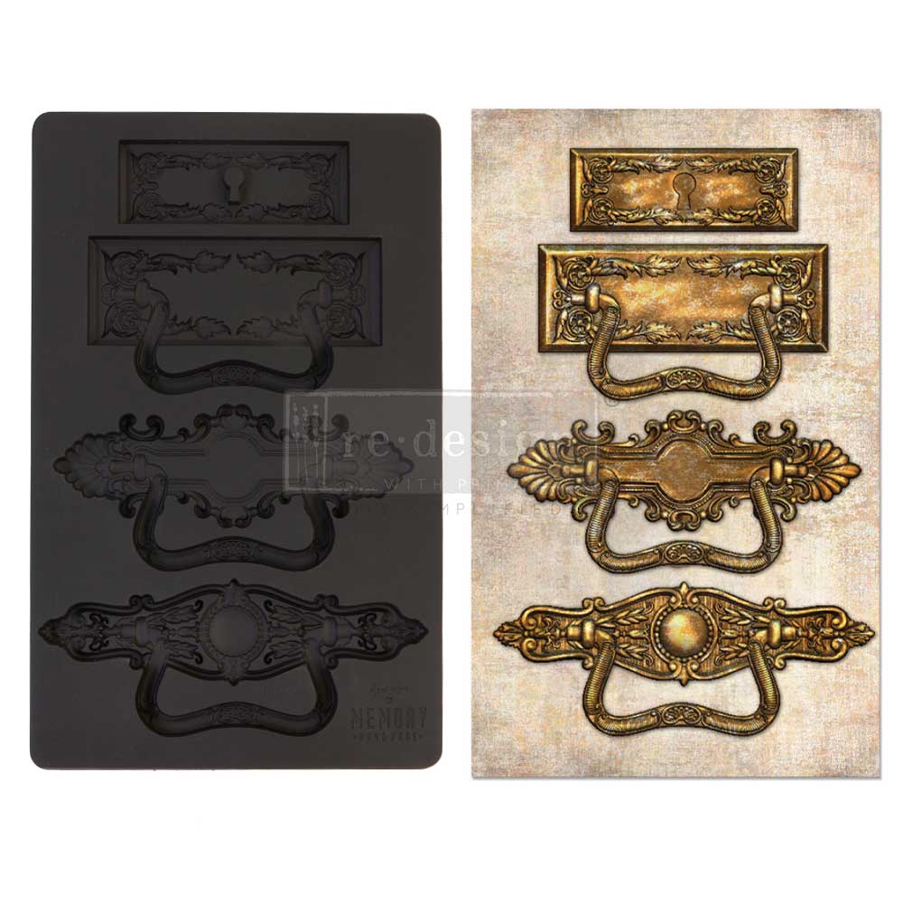 Decorative metal handles in black and gold on a white background